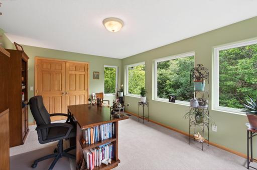 Surrounded by windows and natural light, this flexible space is ideal as a bedroom or office.