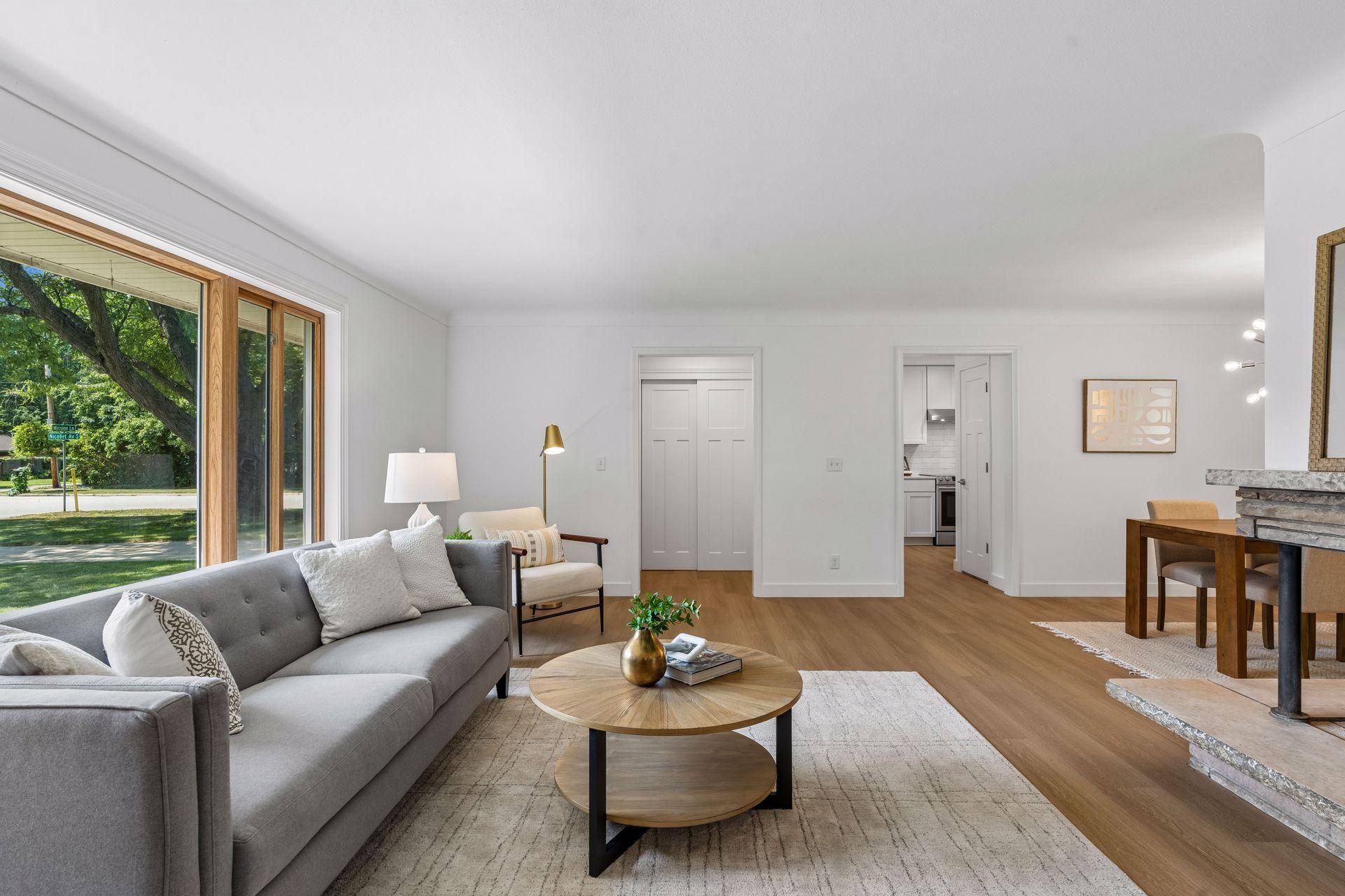 25x15 and 11x9 Living room and dining room with south and north-facing updated windows, new paint, new luxury vinyl flooring, and lighting.