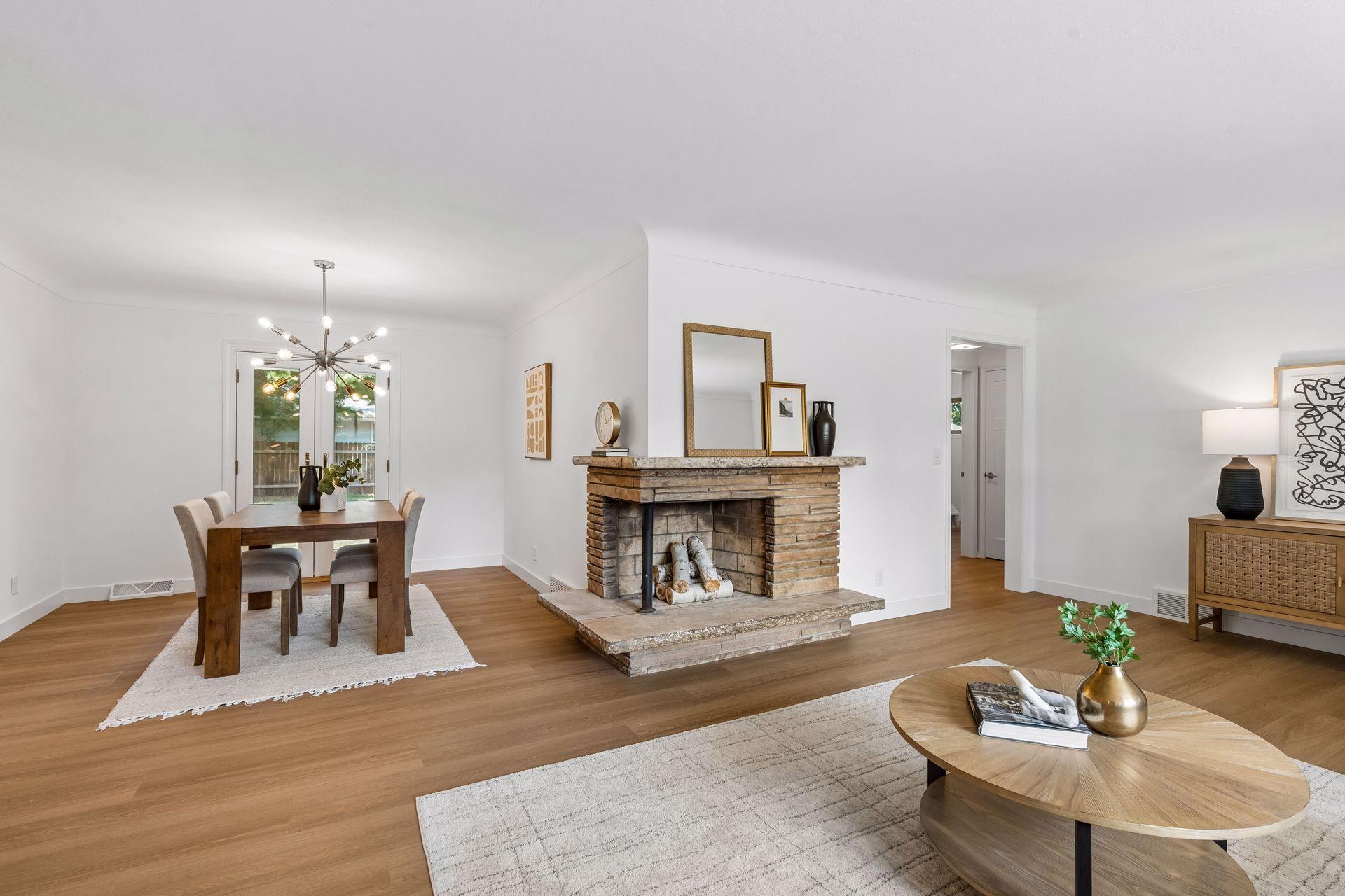 25x15 and 11x9 Living room and dining room with south and north-facing updated windows, new paint, new luxury vinyl flooring, and lighting.
