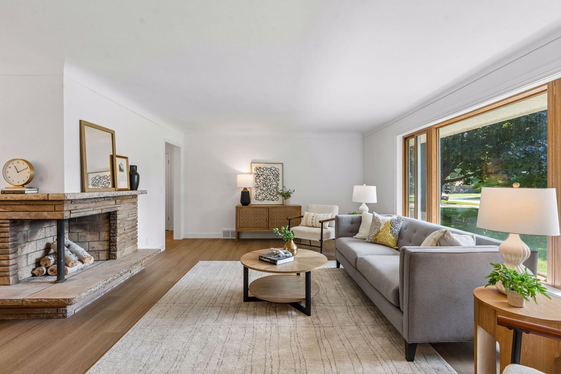 25x15 and 11x9 Living room and dining room with south and north-facing updated windows, new paint, new luxury vinyl flooring, and lighting.