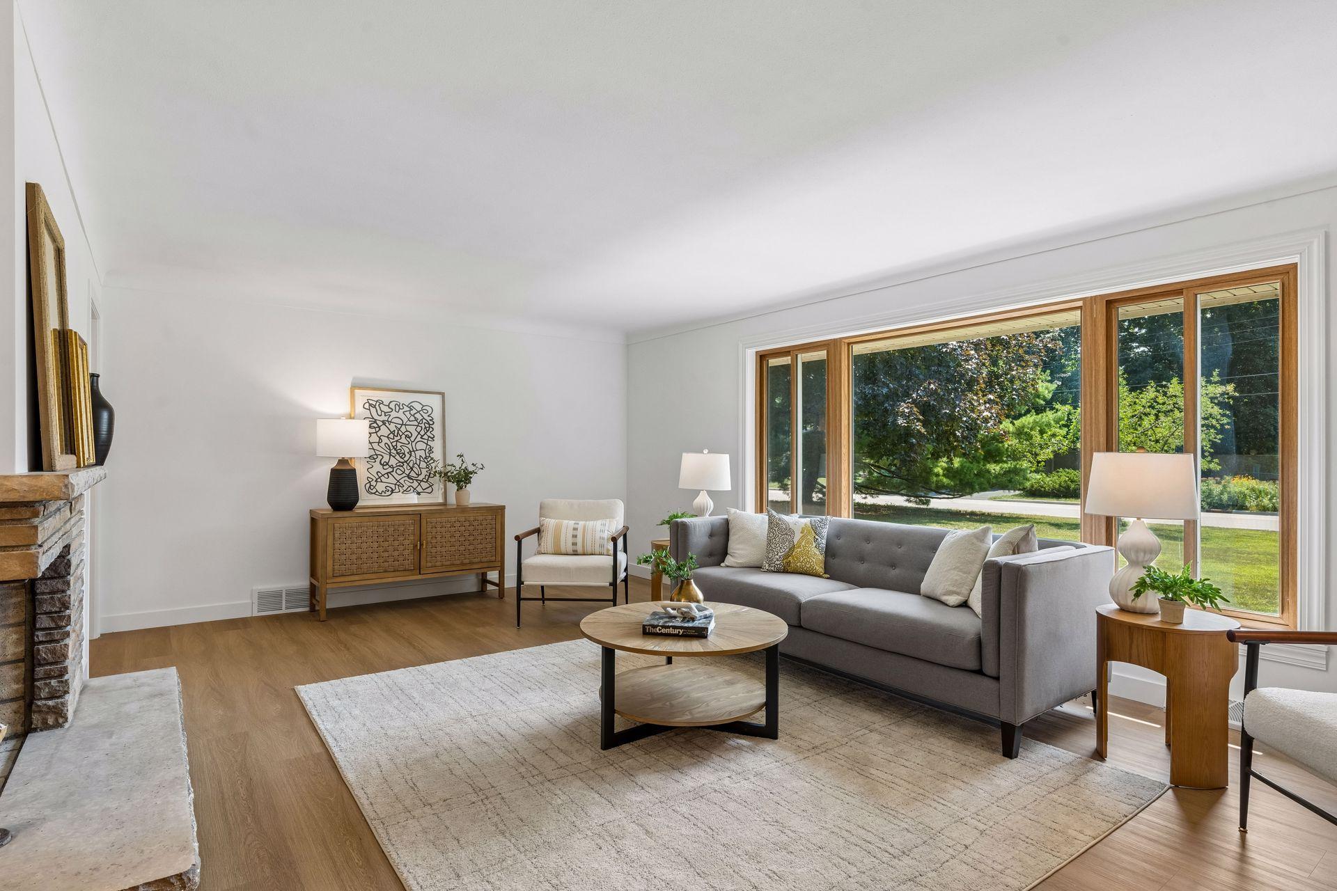25x15 and 11x9 Living room and dining room with south and north-facing updated windows, new paint, new luxury vinyl flooring, and lighting.