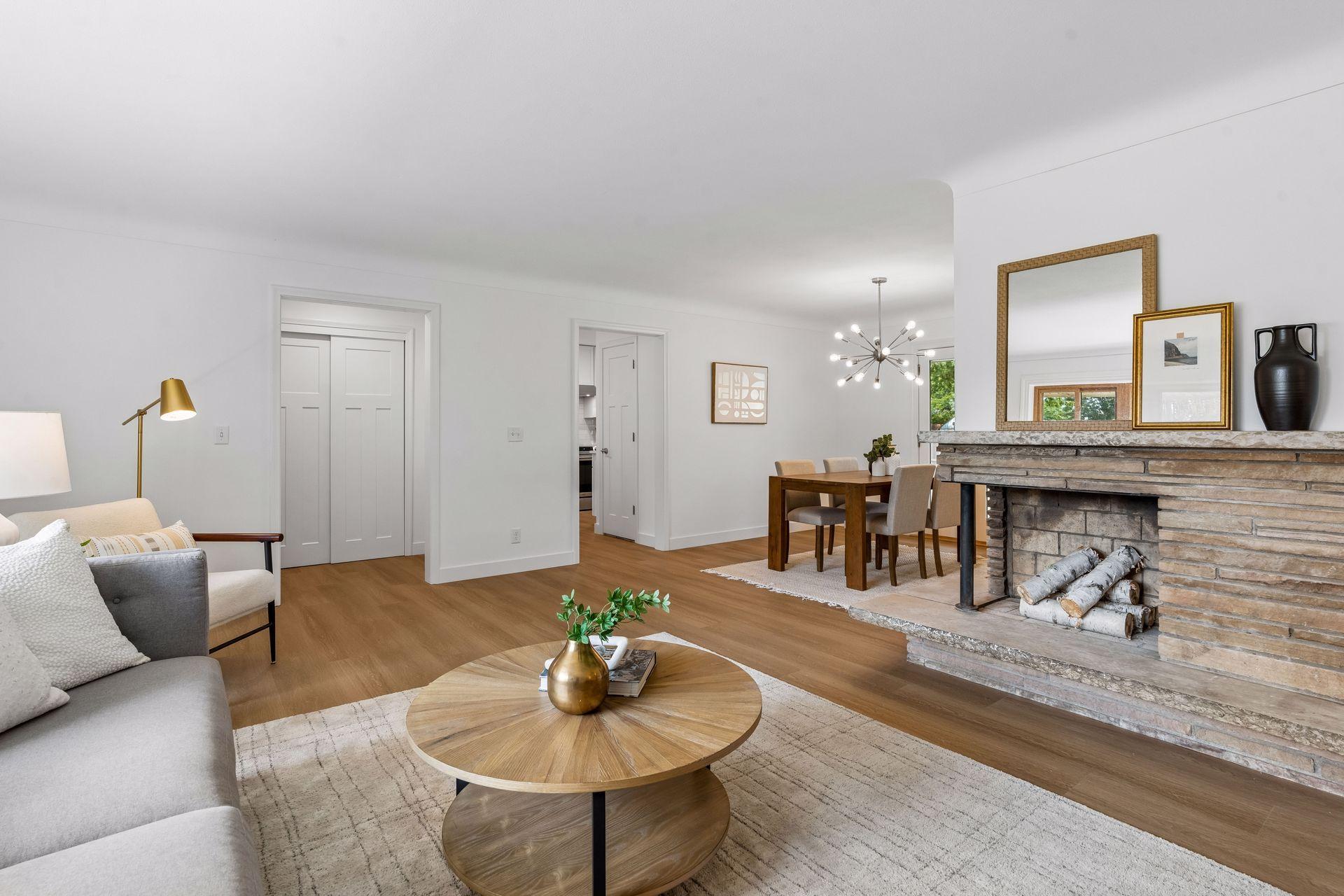 25x15 and 11x9 Living room and dining room with south and north-facing updated windows, new paint, new luxury vinyl flooring, and lighting.