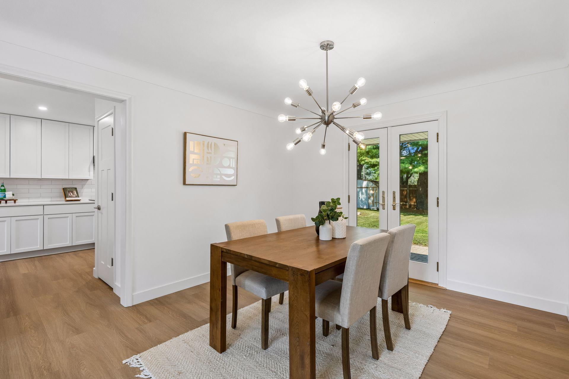 25x15 and 11x9 Living room and dining room with south and north-facing updated windows, new paint, new luxury vinyl flooring, and lighting.