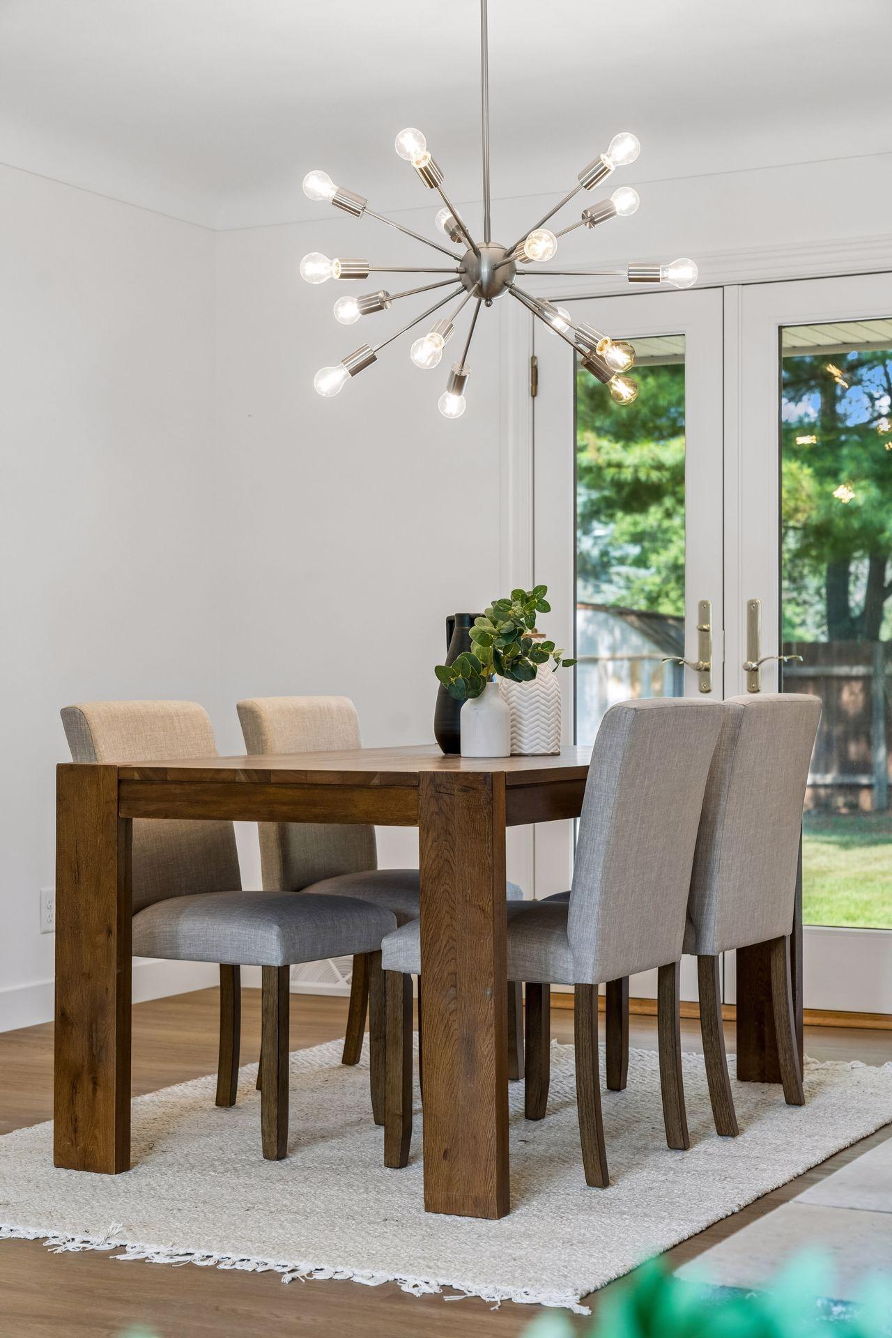 25x15 and 11x9 Living room and dining room with south and north-facing updated windows, new paint, new luxury vinyl flooring, and lighting.
