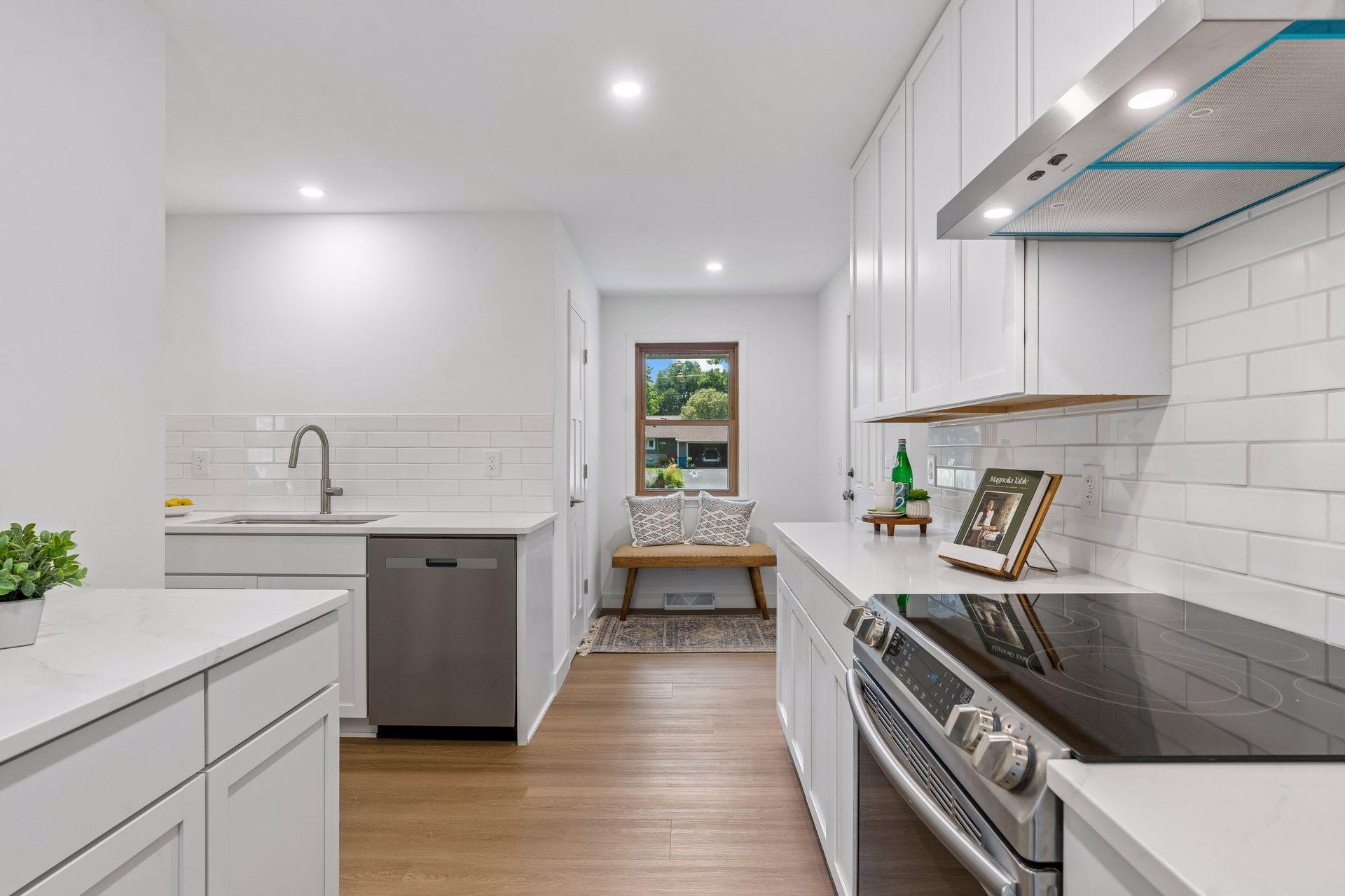 23x12 main Floor Kitchen with south and north-facing updated windows, new paint, new luxury vinyl flooring, and lighting. New shaker-style cabinets, stainless steel appliances, new dishwasher, new quartz countertops, new Undermount sink, and faucet.