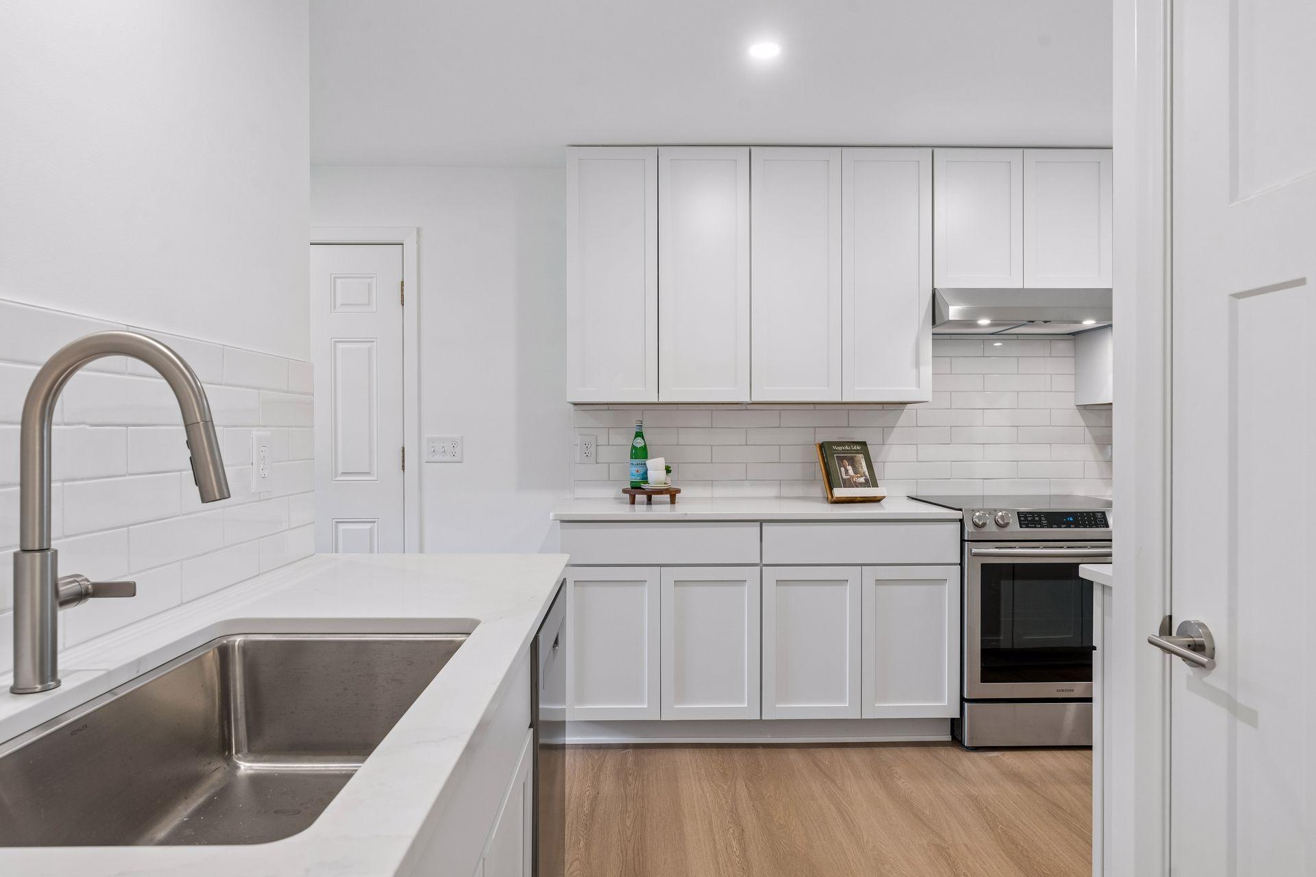 23x12 main Floor Kitchen with south and north-facing updated windows, new paint, new luxury vinyl flooring, and lighting. New shaker-style cabinets, stainless steel appliances, new dishwasher, new quartz countertops, new Undermount sink, and faucet.