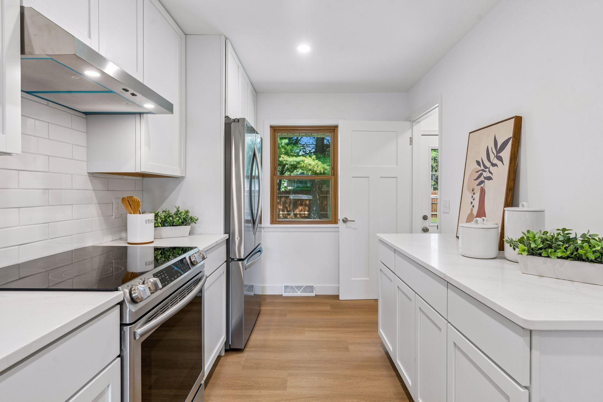 23x12 main Floor Kitchen with south and north-facing updated windows, new paint, new luxury vinyl flooring, and lighting. New shaker-style cabinets, stainless steel appliances, new dishwasher, new quartz countertops, new Undermount sink, and faucet.