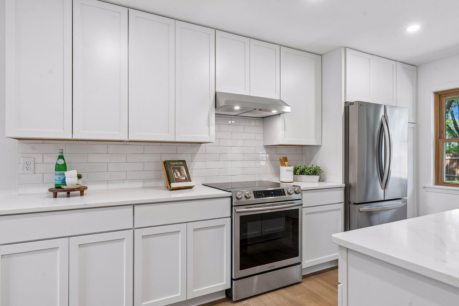 23x12 main Floor Kitchen with south and north-facing updated windows, new paint, new luxury vinyl flooring, and lighting. New shaker-style cabinets, stainless steel appliances, new dishwasher, new quartz countertops, new Undermount sink, and faucet.