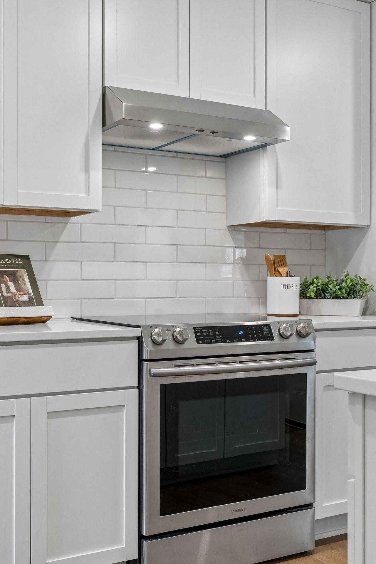23x12 main Floor Kitchen with south and north-facing updated windows, new paint, new luxury vinyl flooring, and lighting. New shaker-style cabinets, stainless steel appliances, new dishwasher, new quartz countertops, new Undermount sink, and faucet.