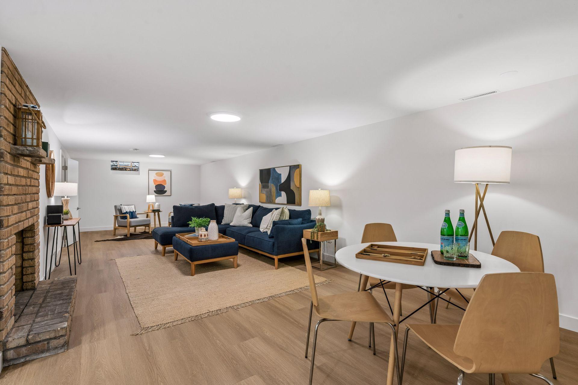 34x14 Lower level Family room with East-facing updated glass block windows, new paint, new luxury vinyl flooring, and lighting.