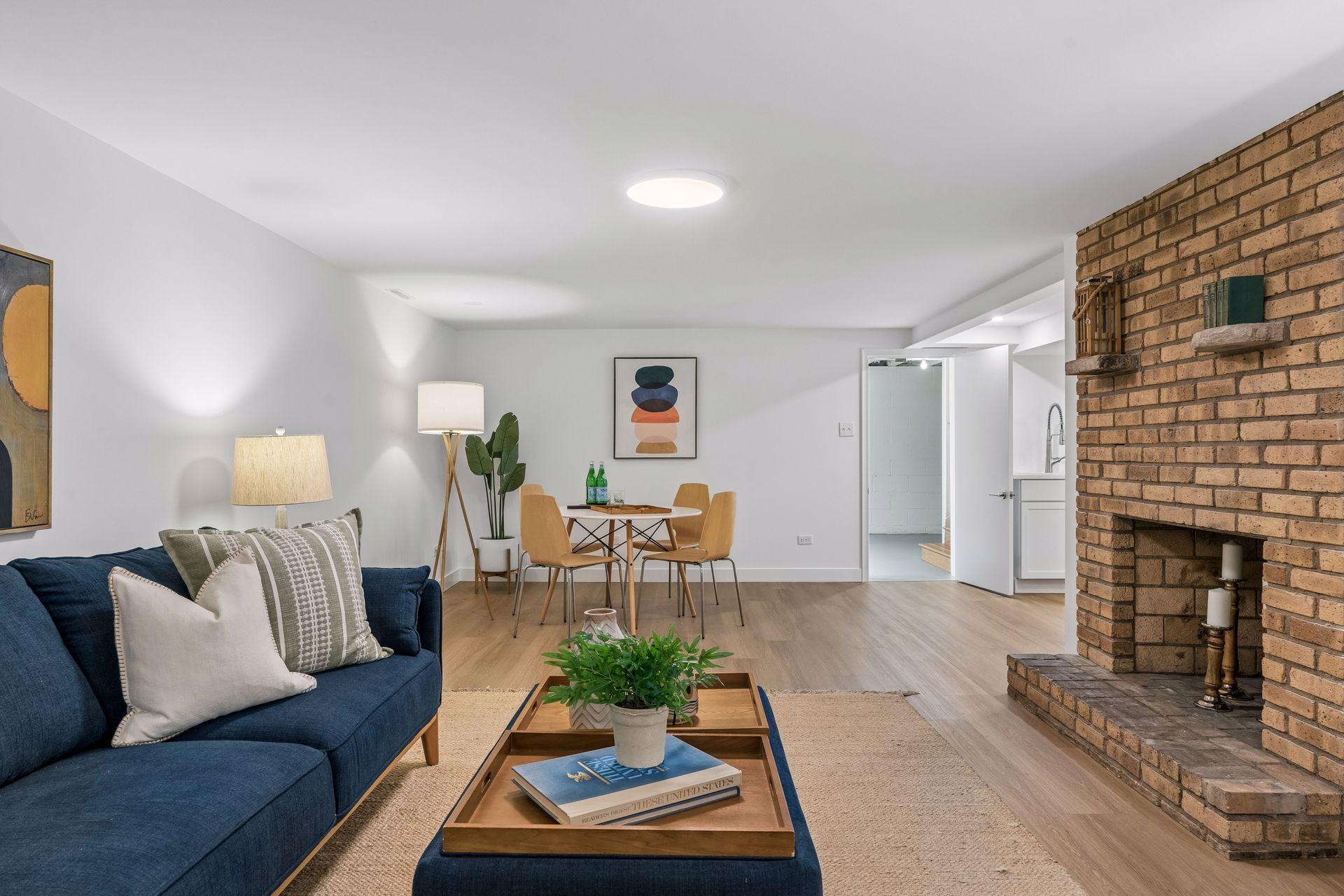 34x14 Lower-level family room with East-facing updated glass block windows, new paint, new luxury vinyl flooring, and lighting.