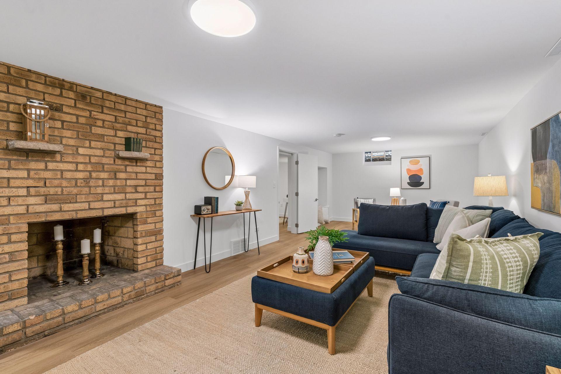 34x14 Lower-level family room with East-facing updated glass block windows, new paint, new luxury vinyl flooring, and lighting.