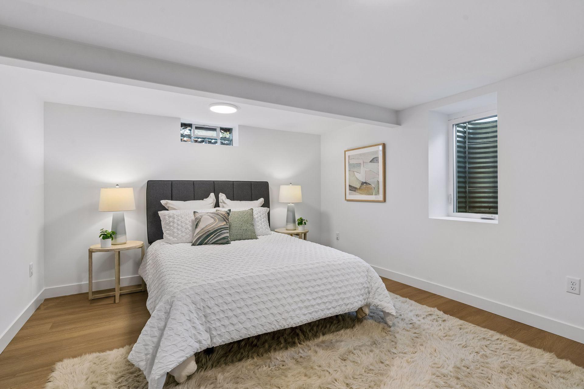 16x13 Lower Level Bedroom #3 with East and north-facing updated Glass block window, New East-facing Egress window, new paint, New trim and closet door, new luxury vinyl flooring, and lighting.