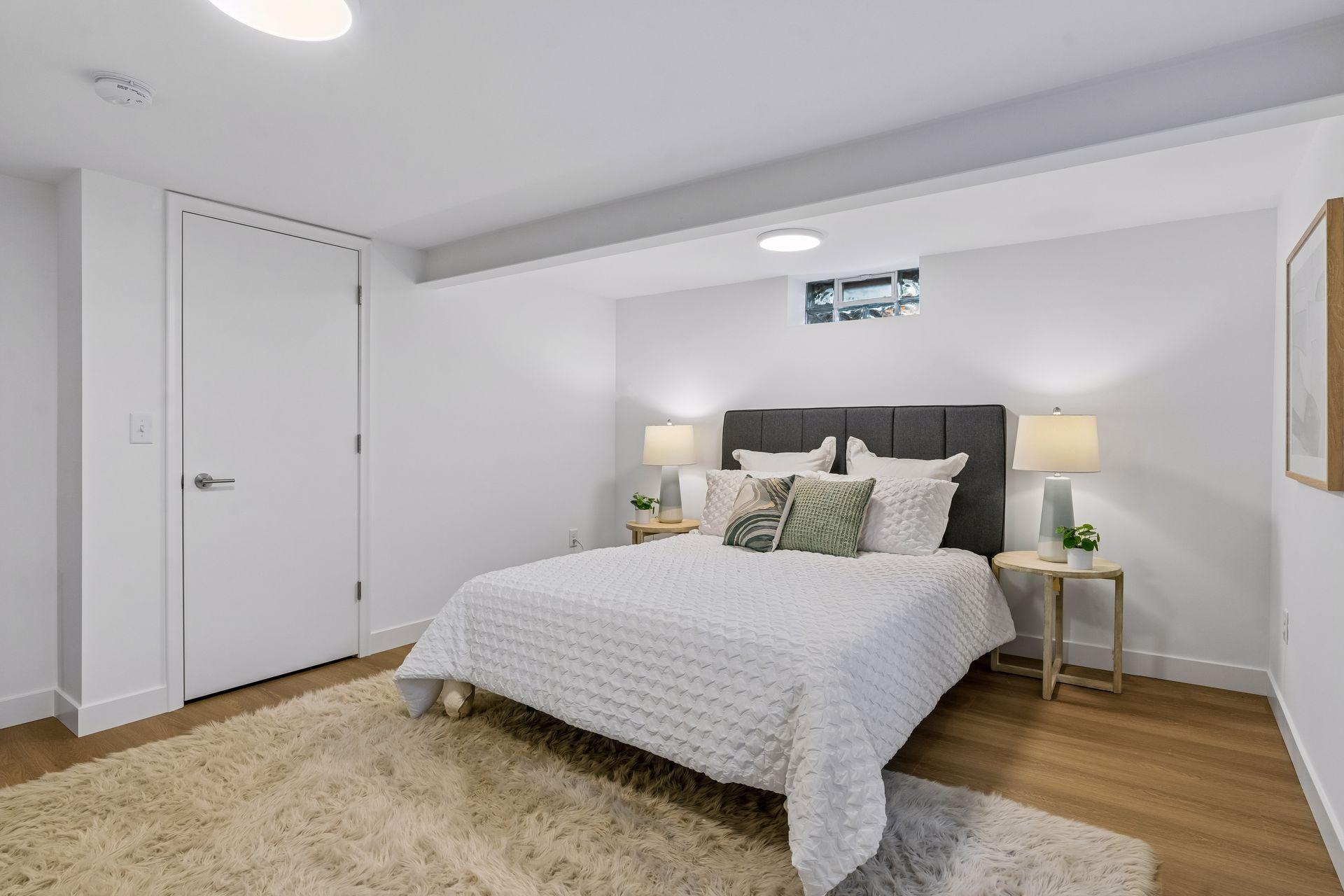 16x13 Lower Level Bedroom #3 with East and north-facing updated Glass block window, New East-facing Egress window, new paint, New trim and closet door, new luxury vinyl flooring, and lighting.