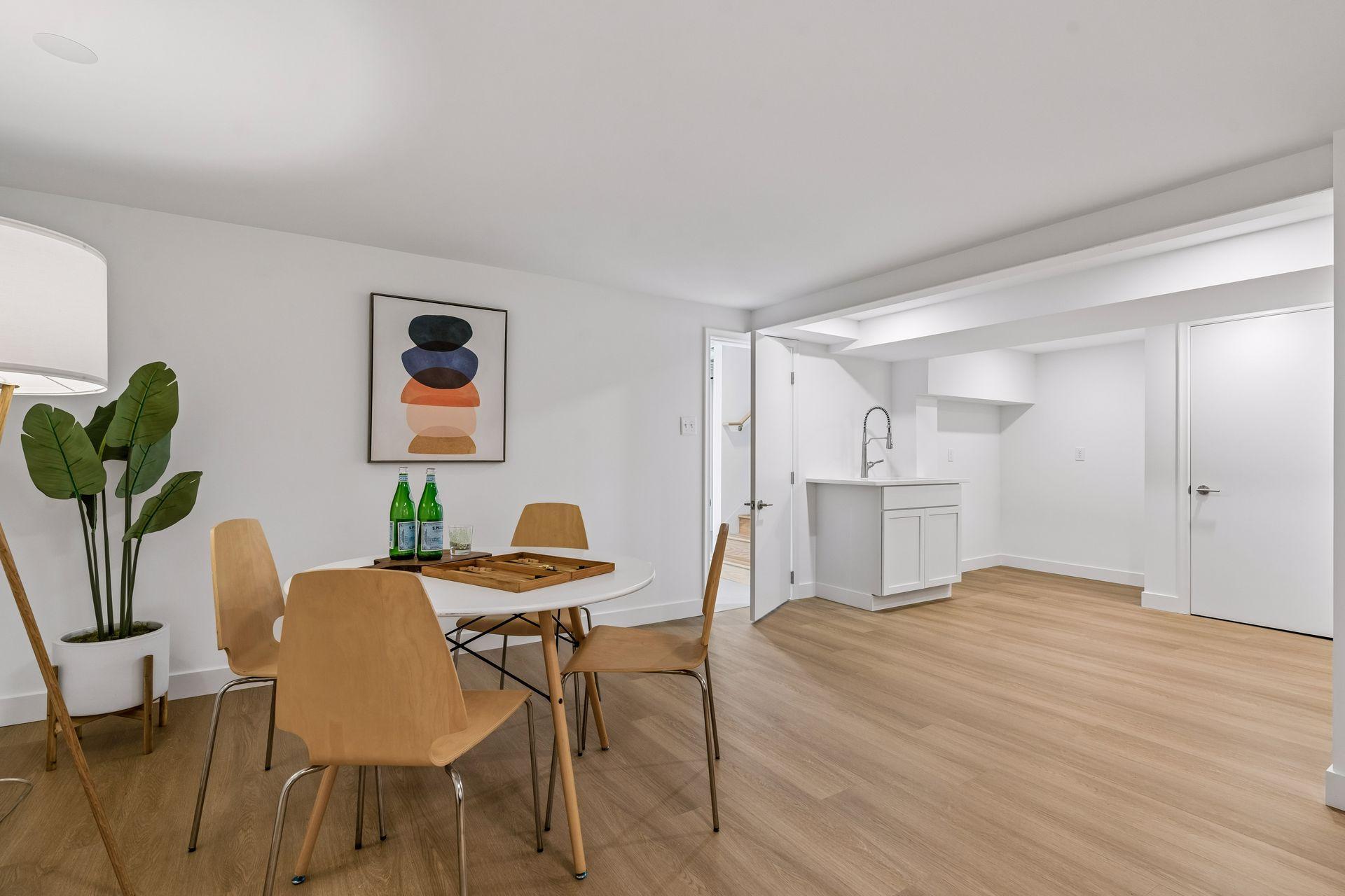 34x14 lower-level family room with East-facing updated glass block windows, new paint, new luxury vinyl flooring, and lighting. New Sink for a possible second kitchen or Bar.