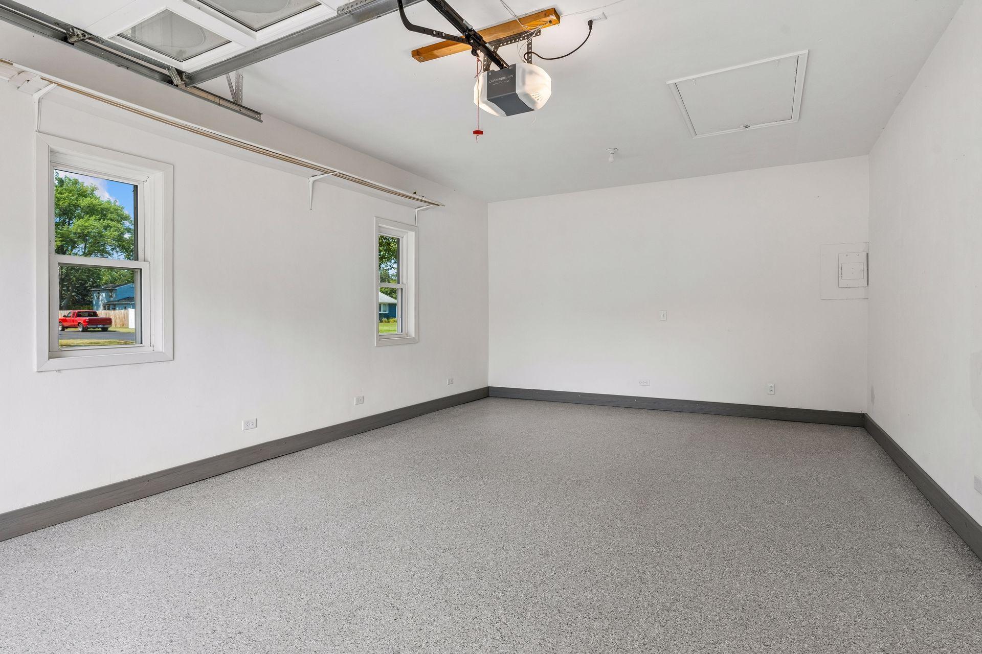 23x15 Attached 1 car finished Garage with new paint and professionally finished epoxy-coated floor with west-facing windows and a new garage door opener