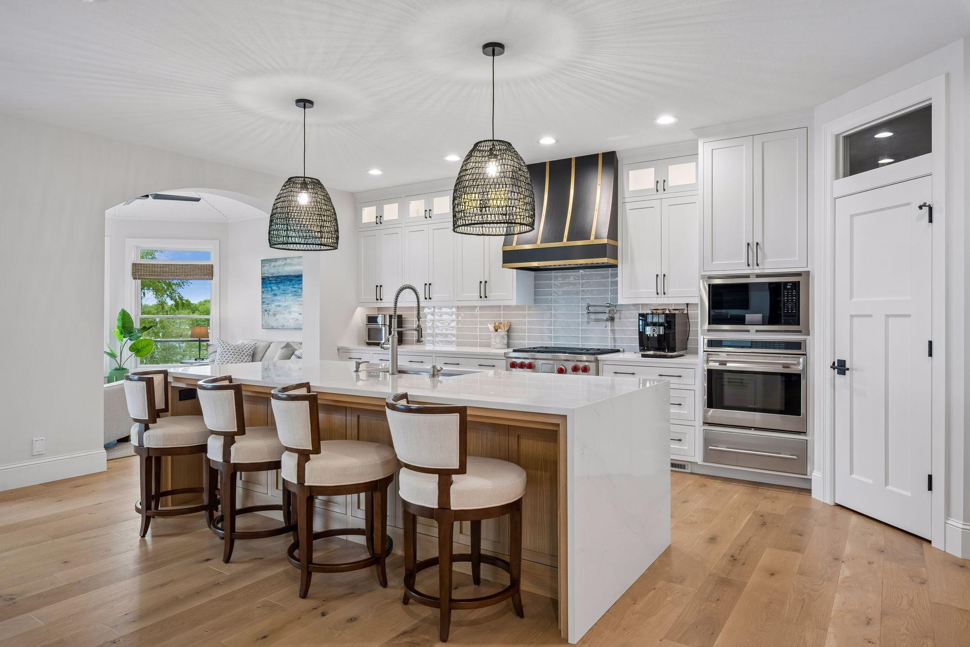 Stunning kitchen with white oak hardwood flooring, wolf & subzero appliances, walk in pantry and large center island with quartzite counter tops.