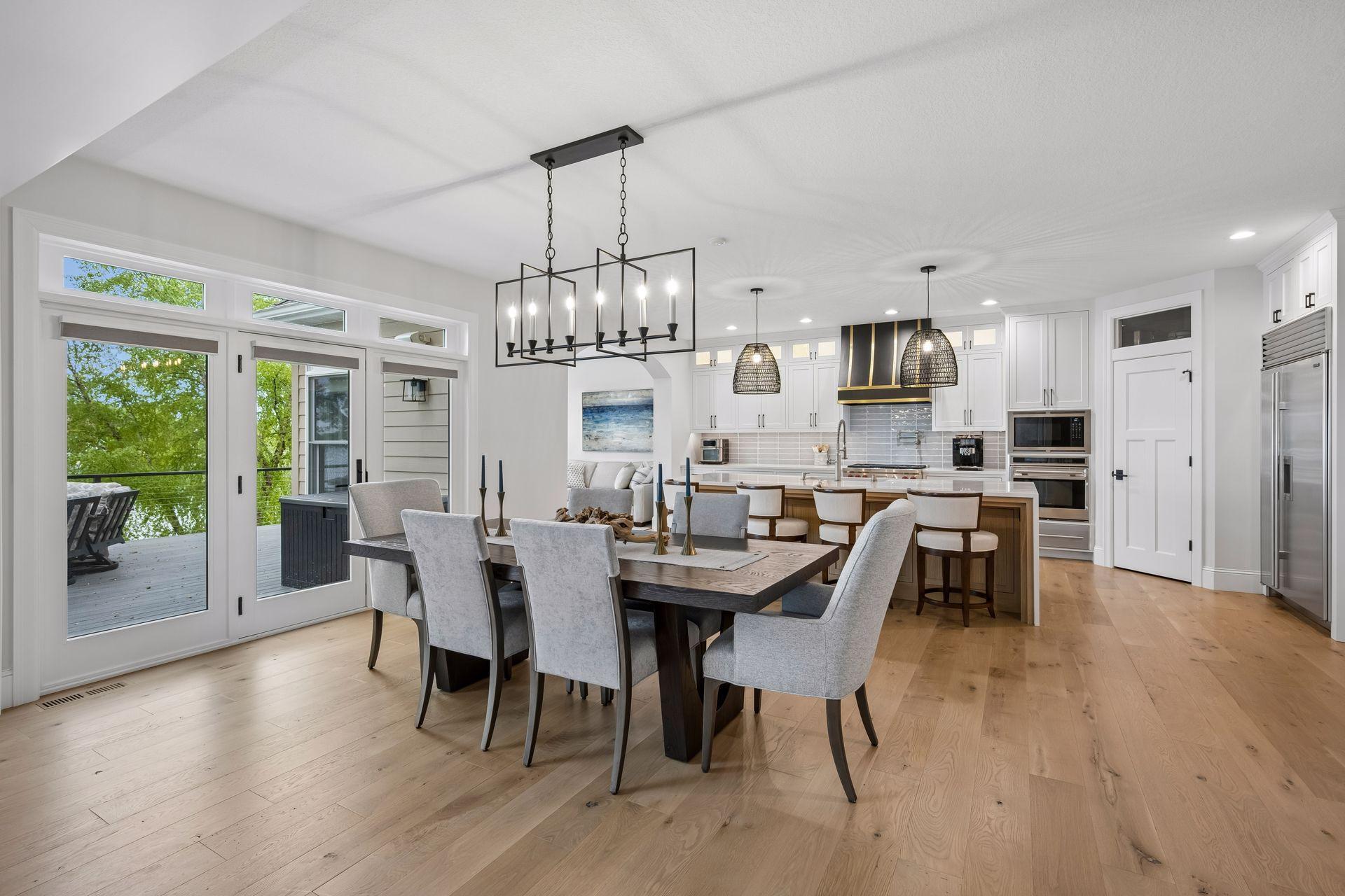 Dining/ kitchen - white oak hardwood floors, tons of natural lighting and steps away from the maintenance free deck over looking the lake.