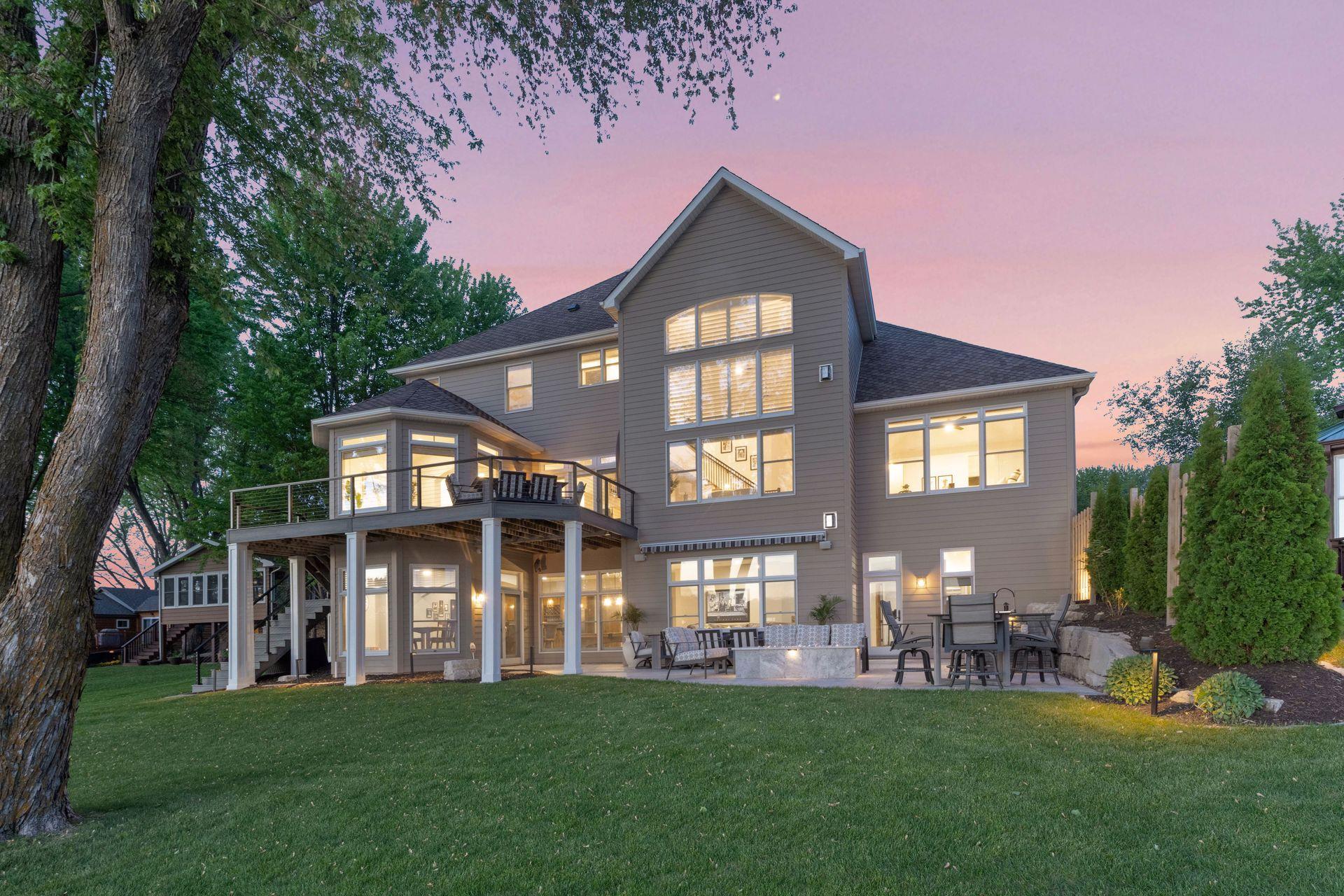 Large patio and maintenance free deck overlooking a manicure lawn & 85' of lake shore on Waverly Lake