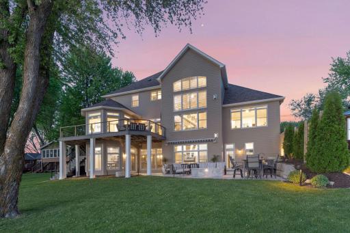 Large patio and maintenance free deck overlooking a manicure lawn & 85' of lake shore on Waverly Lake