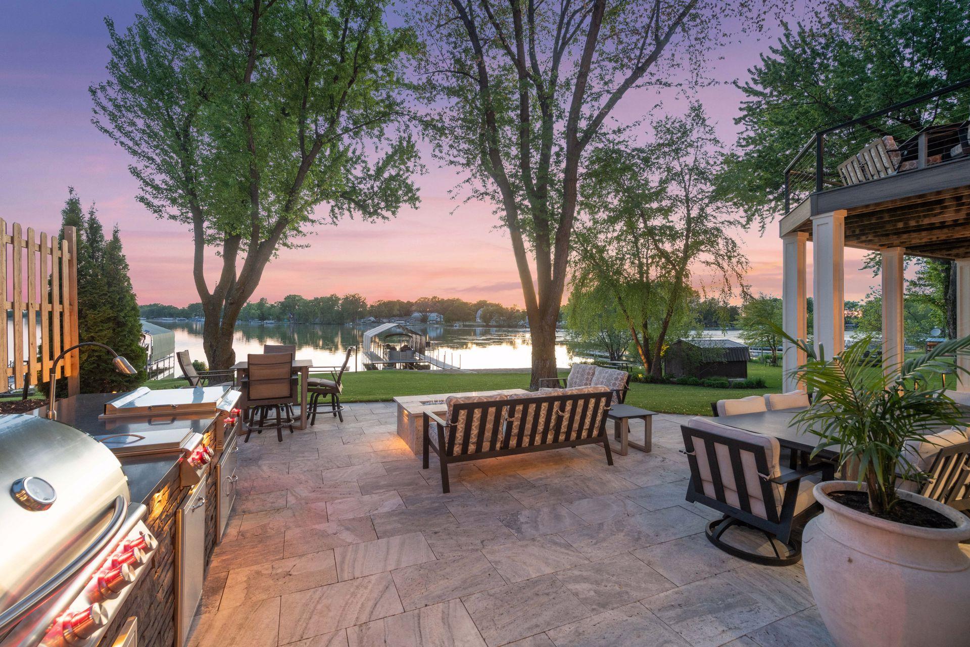 Beautiful sunset views from your expansive travertine patio feature gas fire pit and outdoor gas grill/cooking station.