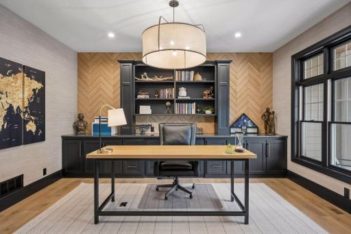 Beautiful executive office complete with granite countertops and custom built-ins, creating an ideal work-from-home setup.