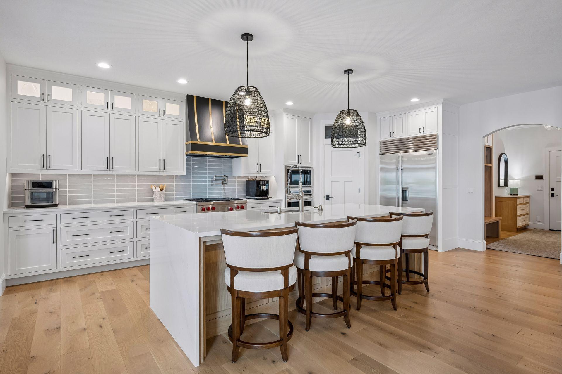 Stunning kitchen with white oak hardwood flooring, wolf & subzero appliances, walk in pantry and large center island with quartzite counter tops.