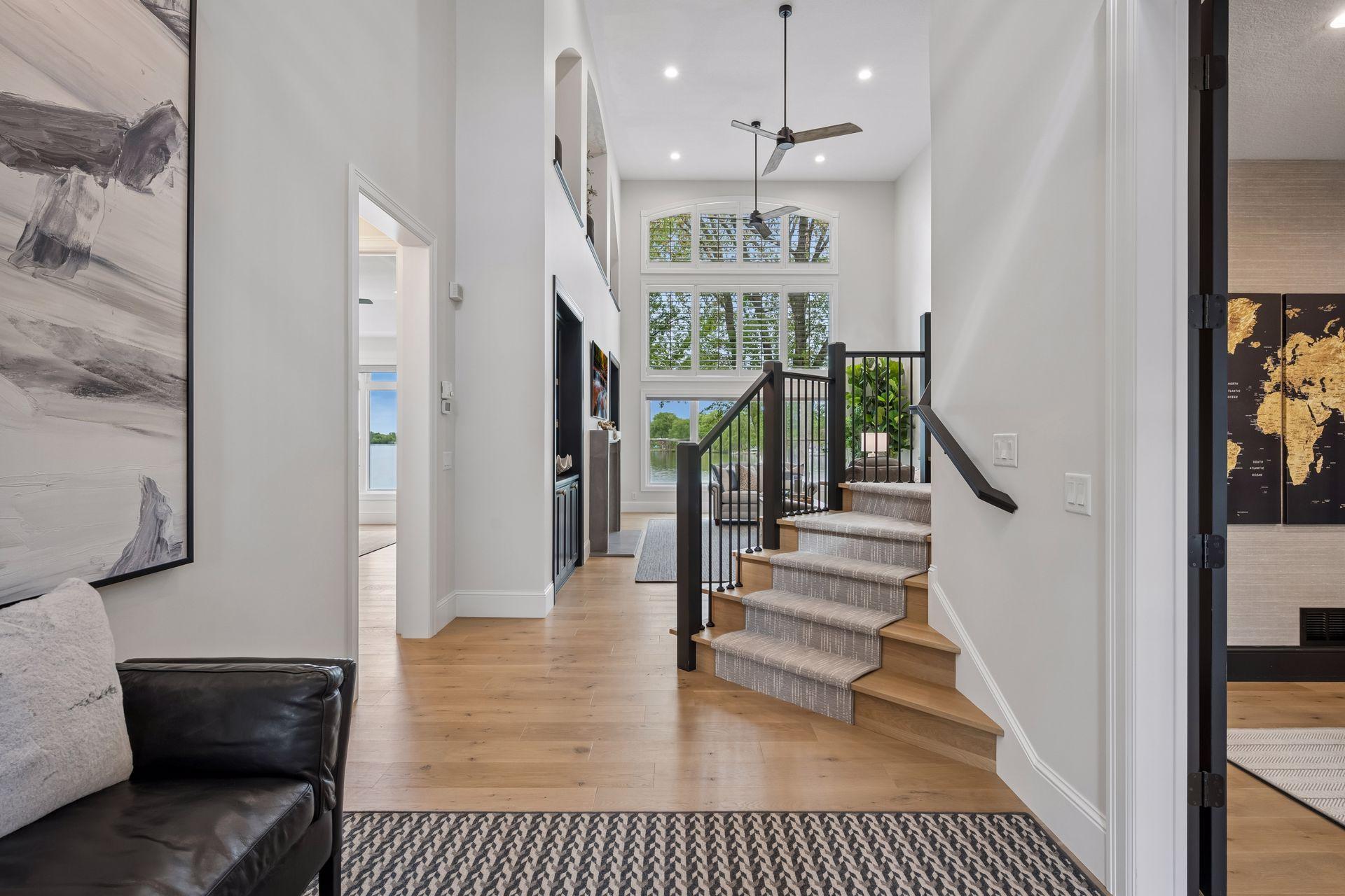 Soaring 19 foot ceilings, beautiful hardwoods, and a view of Waverly lake welcome you as you step inside