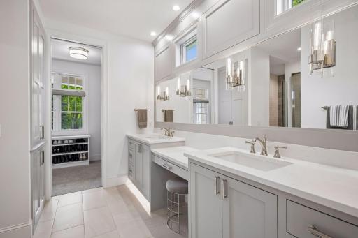 Private primary bathroom with heated floors, under vanity lighting, quartzite countertops on double vanity, large walk in closet.