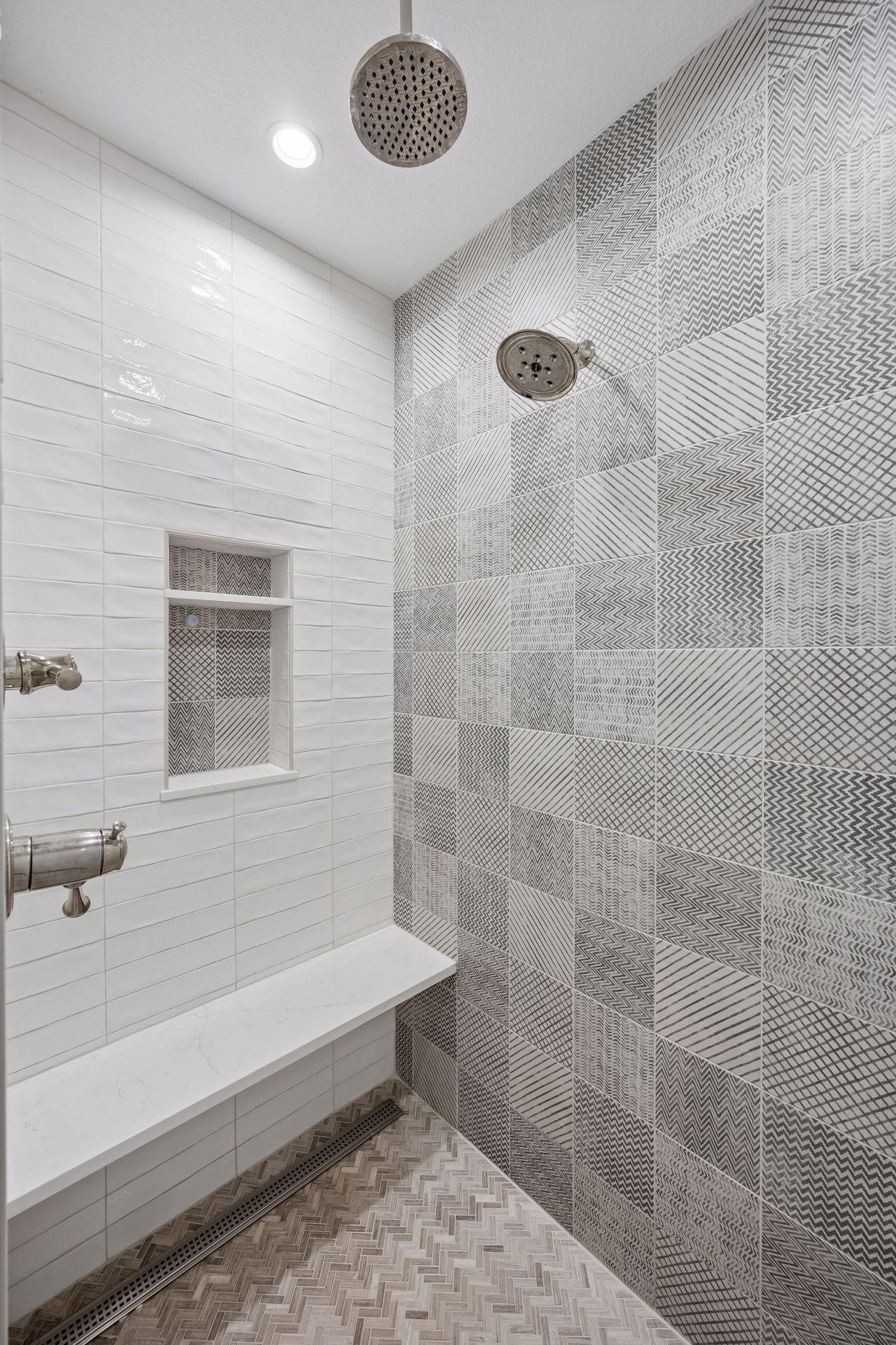 Walk in tile shower with heated floor, dual shower heads including a rain head.