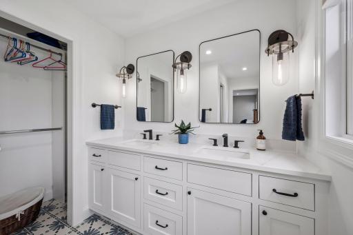 Private bathroom (bedroom 1) double vanity, granite counter tops, tile floors and closet space.