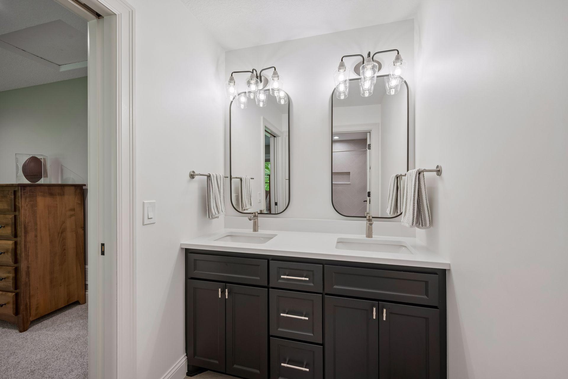 Private bathroom (bedroom 2 ) double vanity, granite counter tops, tile floors and tub with tile surround.