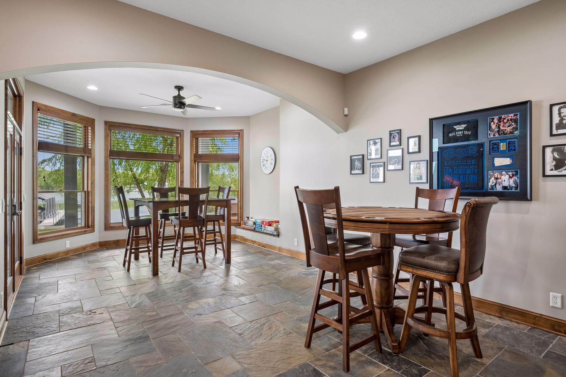 walkout lower level was built for entertaining with soaring 10-foot ceilings, knotty alder trim and doors, custom built-ins, oversized lake-facing windows, full wet bar with granite countertops, full-size refrigerator, dishwasher,