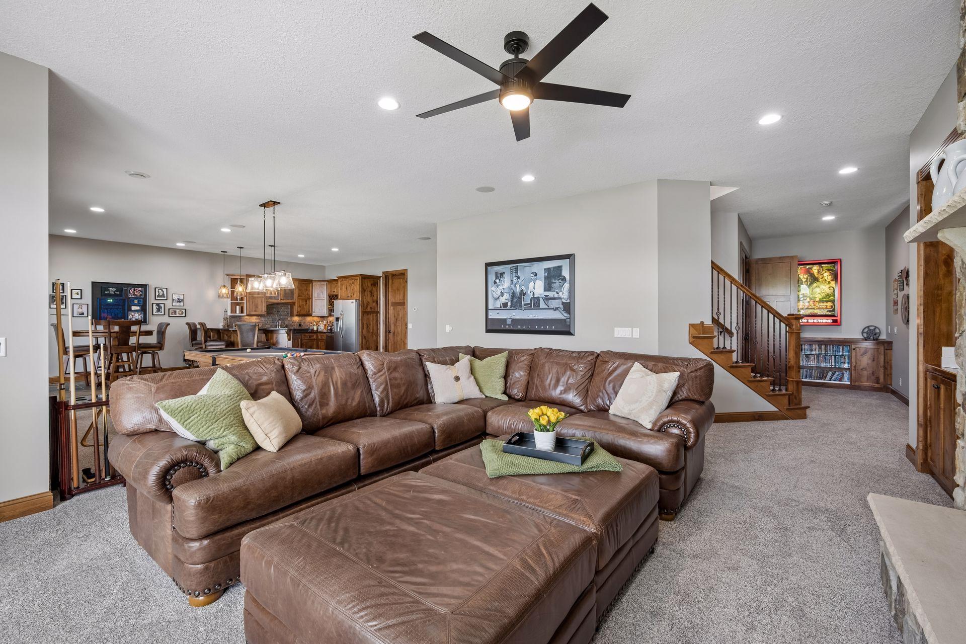 walkout lower level was built for entertaining with soaring 10-foot ceilings, knotty alder trim and doors, custom built-ins, oversized lake-facing windows, full wet bar with granite countertops, full-size refrigerator, dishwasher,