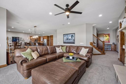 walkout lower level was built for entertaining with soaring 10-foot ceilings, knotty alder trim and doors, custom built-ins, oversized lake-facing windows, full wet bar with granite countertops, full-size refrigerator, dishwasher,
