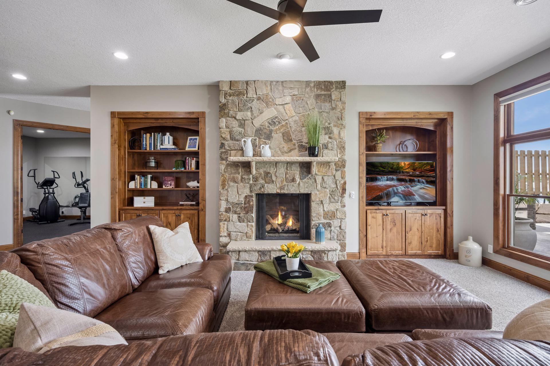 walkout lower level was built for entertaining with soaring 10-foot ceilings, knotty alder trim and doors, custom built-ins, oversized lake-facing windows, full wet bar with granite countertops, full-size refrigerator, dishwasher,