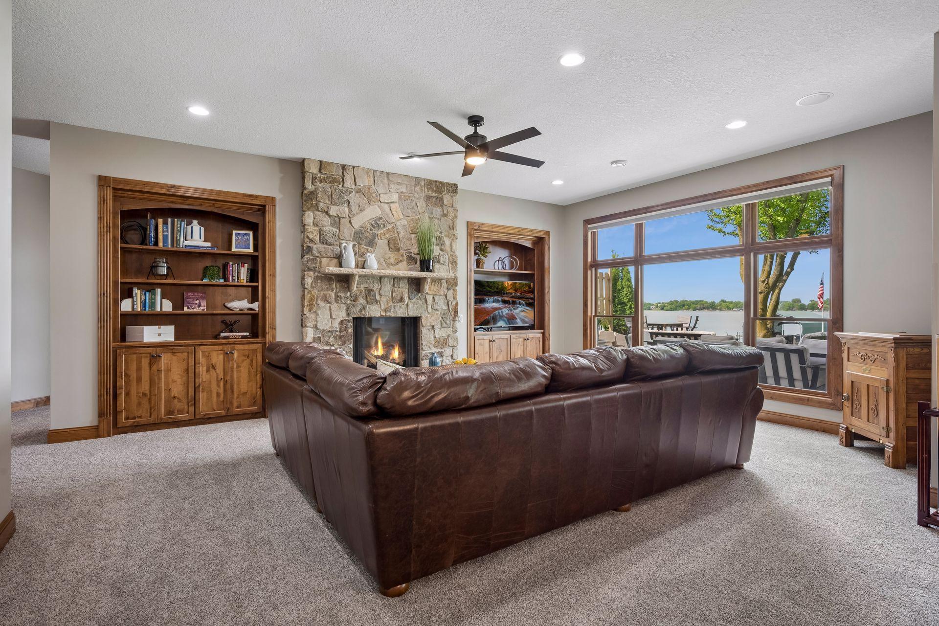 walkout lower level was built for entertaining with soaring 10-foot ceilings, knotty alder trim and doors, custom built-ins, oversized lake-facing windows, full wet bar with granite countertops, full-size refrigerator, dishwasher,