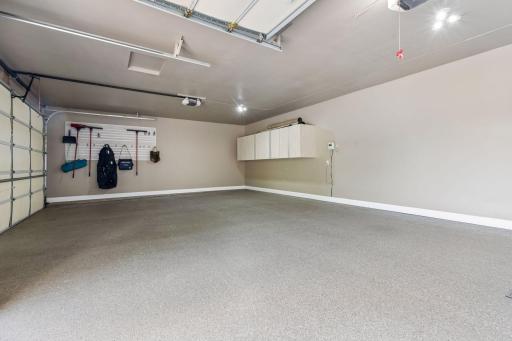 Car enthusiasts will appreciate the three-car attached garage with epoxy floors and California Closets cabinetry, a brand-new asphalt driveway, and an additional tuck-under garage for extra storage.