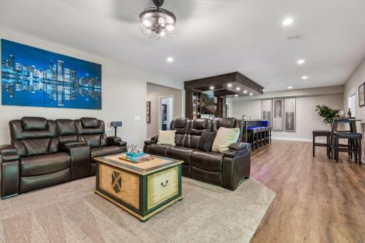 The walkout lower level is both cozy and refined, featuring a family room, a beautiful wet bar with granite leathered countertops, a workout room, and a guest bedroom.
