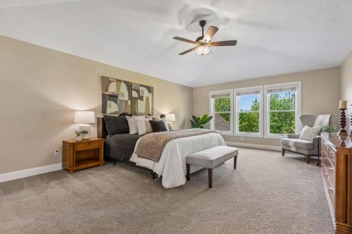 Upstairs, the primary suite and three additional bedrooms are enhanced by custom bathrooms featuring floor-to-ceiling showers with elegant stone trim. The luxurious primary bathroom also boasts heated floors for added comfort.