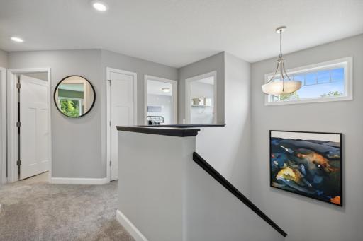 (Photo of a decorated model, actual finishes will vary.) The upstairs hallway ensures each room can be visited with ease.