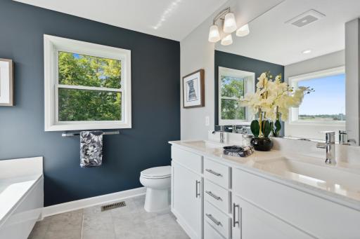 (Photo of a decorated model, actual finishes will vary.) Dual sinks promote streamlined morning routines.