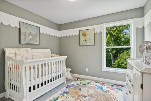 (Photo of a decorated model, actual finishes will vary.) Three secondary bedrooms are situated upstairs, just down the hall from the ownerâs suite.