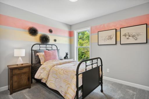 (Photo of a decorated model, actual finishes will vary.) All the secondary bedrooms include a practical wardrobe closet and wall-to-wall carpeting for plush comfort.