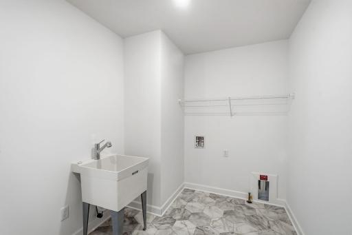 Located on the same floor as all the bedrooms is a spacious laundry room with a rinse sink to conduct daily chores and organizational tasks.