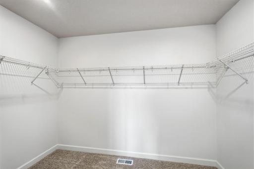 Fit for expansive wardrobes, this oversized walk-in closet comes with mesh-wire shelving to optimize organization and maximize storage space