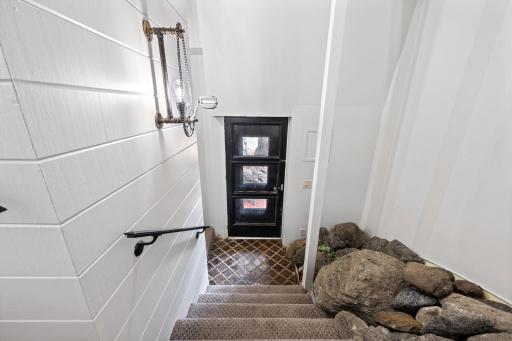 Unique sunken entry with integrated natural stone brings the outdoors in and creates a memorable architectural moment upon arrival