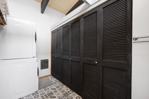 Laundry space tucked behind the kitchen provides ample storage