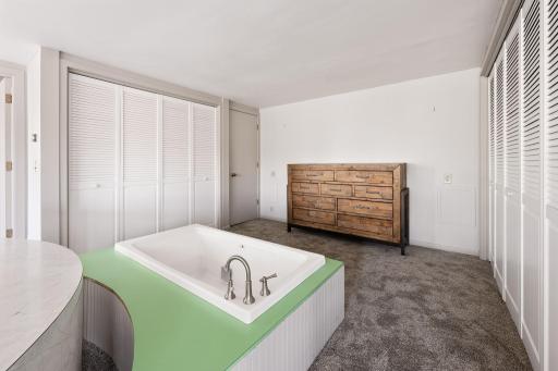 Distinctive primary suite with integrated soaking tub, can be enjoyed as-is or reimagined to suit your preferences