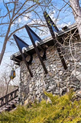 Architectural exterior with exposed steel supports and stone construction